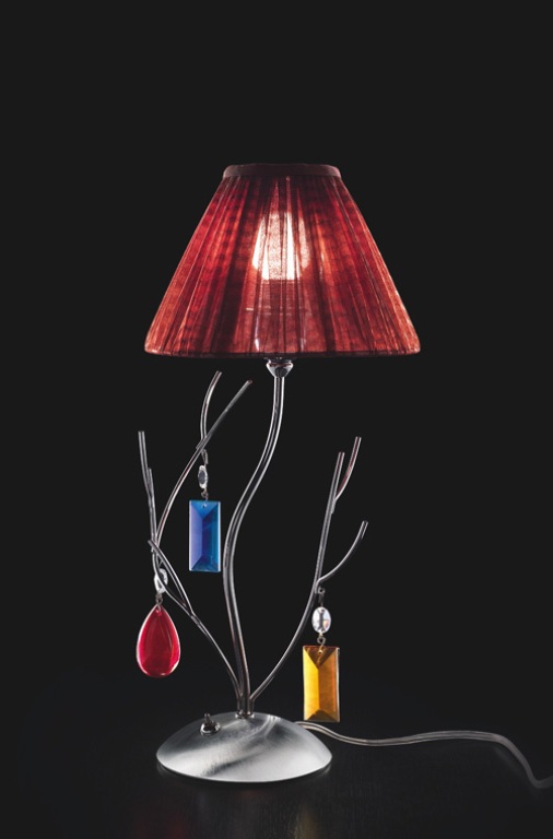a refined table lamp with branches and colorful jewels hanging on them plus a burgundy lampshade for a modern or contemporary space