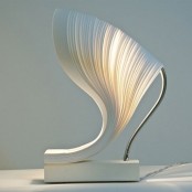 a unique sculptural table lamp with a white base, a textural white lampshade for a minimalist space