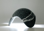 a curved black stone table lamp shaped as a drop is a cool decor idea with much texture
