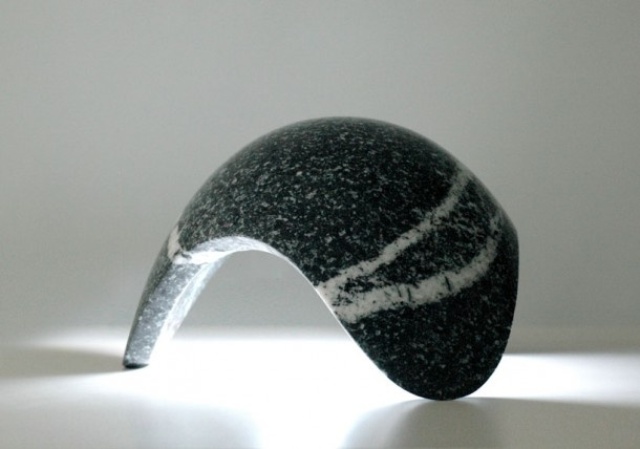 a curved black stone table lamp shaped as a drop is a cool decor idea with much texture