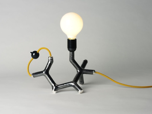 a fun chemistry inspired table lamp in gold, black and with a bulb is a cool and catchy idea