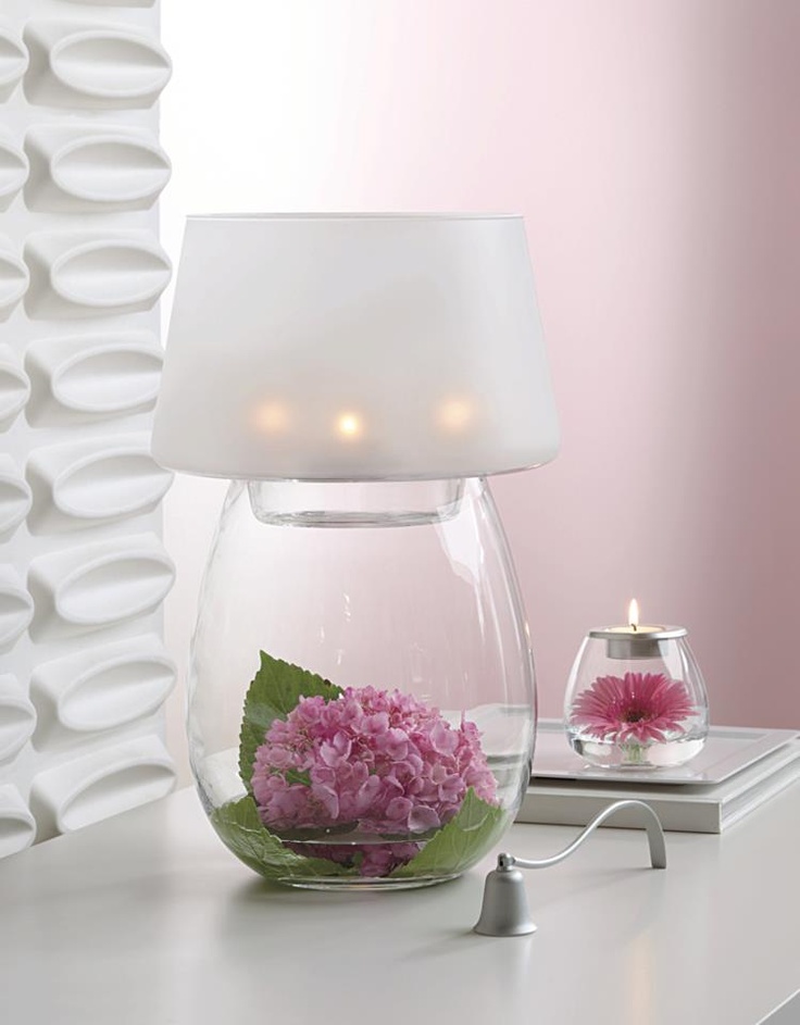 a romantic table lamp with a glass base   you can place anything inside, here there are blooms and greenery