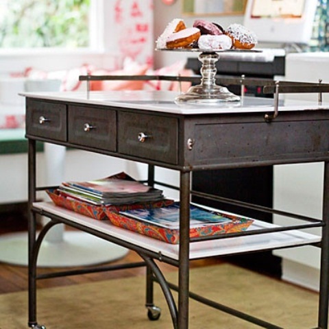 an elegant thin vintage metal kitchen island with drawers and on casters plus a shelf and a white tabletop