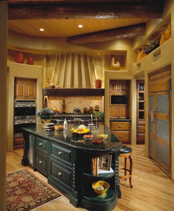 an asymmetrical teal kitchen island with a black stone countertop, drawers and open storage compartments