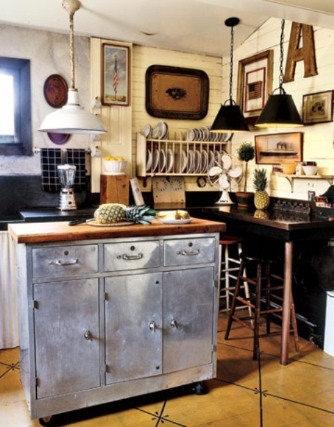 a contrasting kitchen island of metal with a wooden tabletop and storage compartments looks unusual and adds an industrial feel