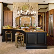 a black oversized and curved kitchen island with a wooden countertop is enough for cooking and eating