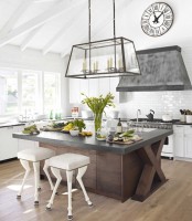 a dark stained wood kitchen island with a wooden countertop makes a bold statement in a white kitchen with a vintage twist