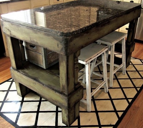 a shabby dark stained wood kitchen island with a polished stone tabletop will give much space for cooking and even for eating