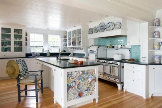 a usual black and white kitchen island is made unique with colorful mosaics on the side