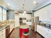 a long curved hot red kitchen island with a stone countertop is a great idea for  anarrow kitchen, it won’t take much space