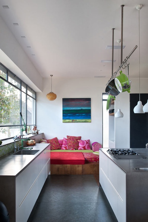 a contemporary kitchen island with white drawers and a concrete countertop is a cool and sleek idea