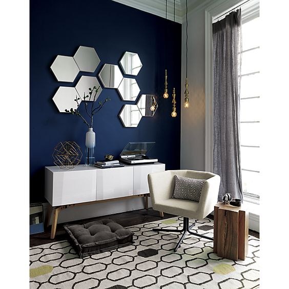 an arrangement of hexagon-shaped mirrors on the wall will make it more eye-catchy and cool and will bring a cool and edgy touch to the room