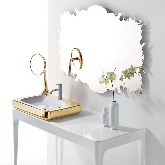 a unique and catchy shaped mirror with beautiful edges, a metallic sink with an additional mirror is a great idea for a sophisticated bathroom