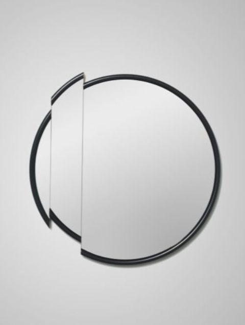 a classic round mirror with a slice of it cut out is a gorgeous take on a classic round mirror, it will make the space bolder and cooler