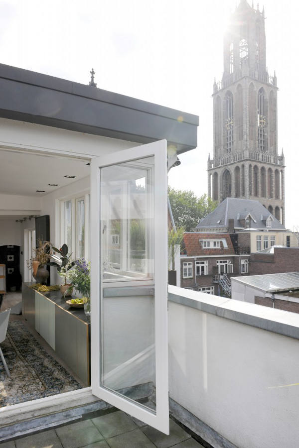 Penthouse Decorated In Eclectic Style With A Black Kitchen