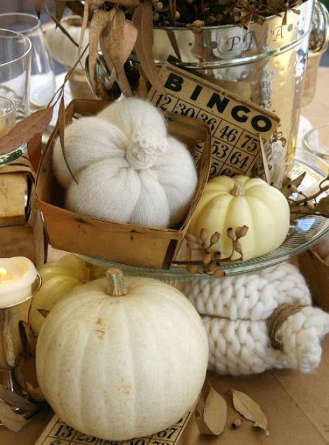 vintage rustic Thanksgiving decor - knit and crochet pumpkins and neutral ones, candles and dried leaves look very decadent
