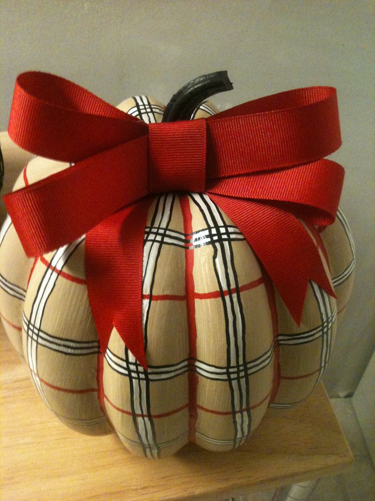 a tan plaid pumpkin with a large red bow on top is a lovely Thanksgiving decoration or you can make one for the fall