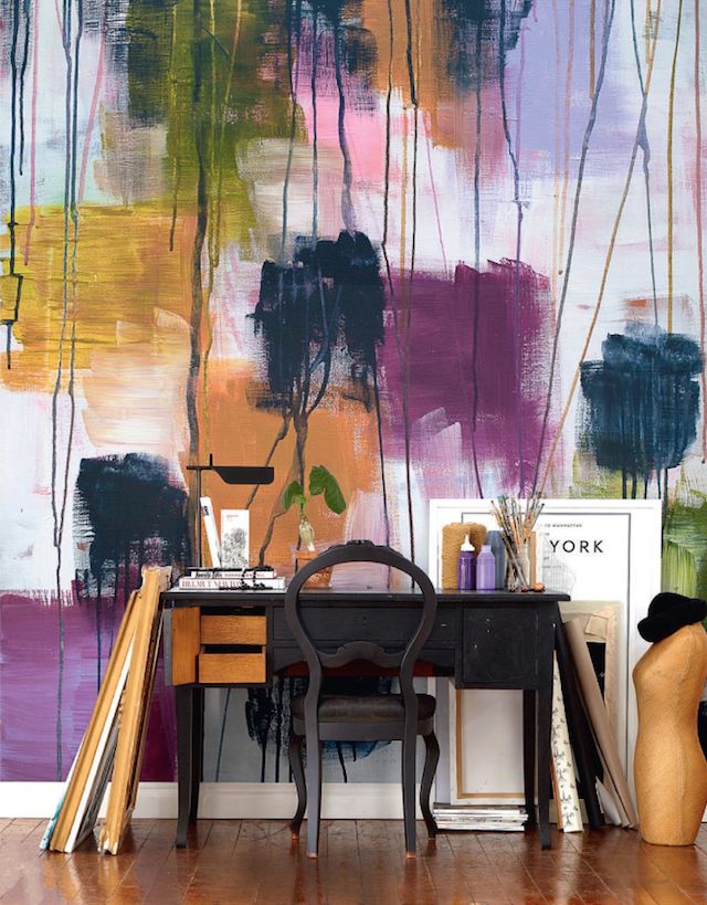 a jaw dropping art studio with a fantastic bright watercolor accent wall, a black desk and a chair, a table lamp and some decor is a fun and cool idea