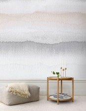 a neutral watercolor accent wall makes a soft yet catchy statement in the space, it’s a nice and delicate accent in a neutral space