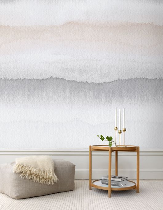 a neutral watercolor accent wall makes a soft yet catchy statement in the space, it's a nice and delicate accent in a neutral space