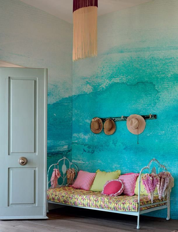 a lovely space with a turquoise watercolor wall