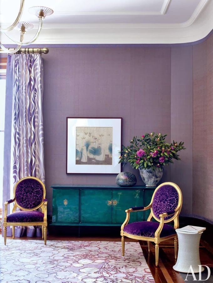 a sophisticated purple living room with lilac curtains, gorgeous antique purple and gold chairs and an emerald credenza