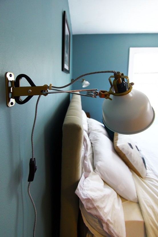 a welcoming bedroom with a wall sconce - an IKEA Ranarp one, which will add coziness to the space
