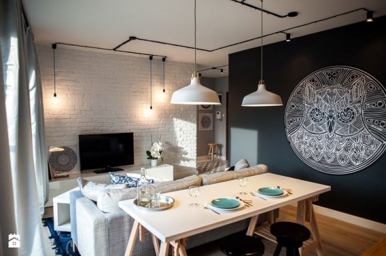 a dining space lit up with white IKEA Ranarp lamps over the table is a lovely and cool idea to rock