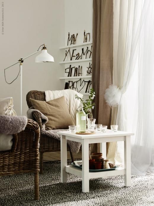 a farmhouse living room with a white IKEA Ranarp lamp and rattan chairs for creating a conversation or reading nook