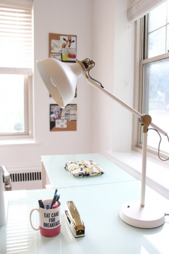 a contemporary work space with a white IKEA Ranarp table lamp that matches the work nook and brings light and style to the space