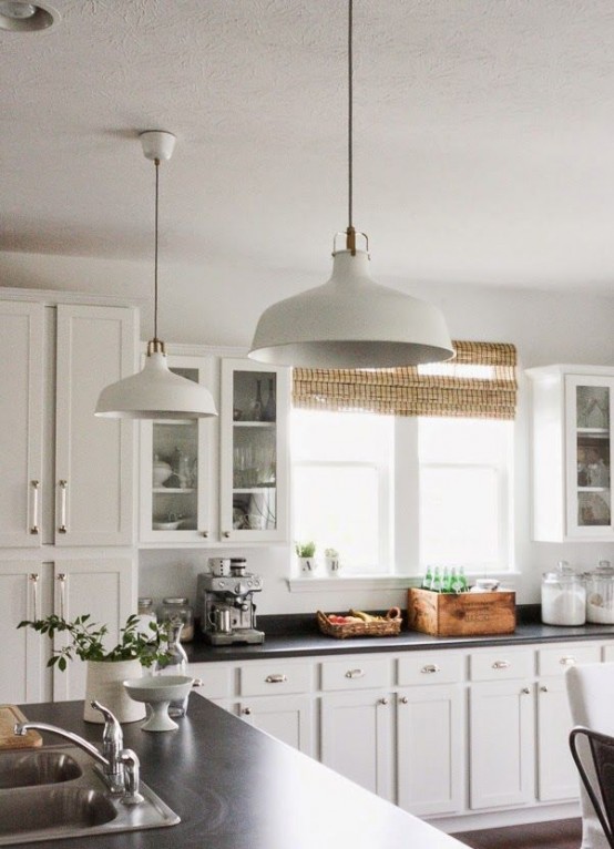 white IKEA Ranarp lamps used as pendant ones in this white farmhouse kitchen add chic and highlight the style