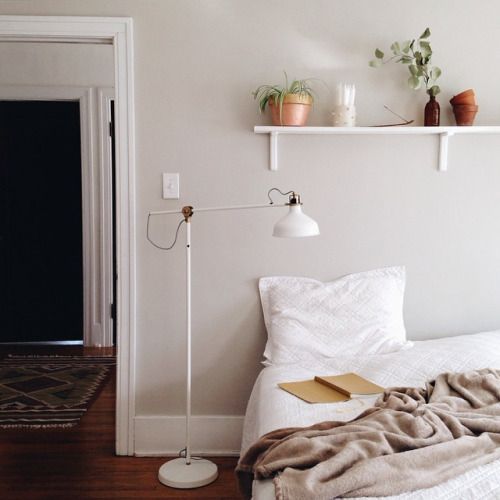 a white IKEA Ranarp floor lamp will be a nice source of light for your neutral and chic bedroom