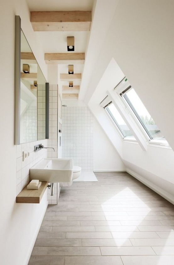 a modern white bathroom with windows, a floating vanity, a large mirror and wooden beams on the ceiling