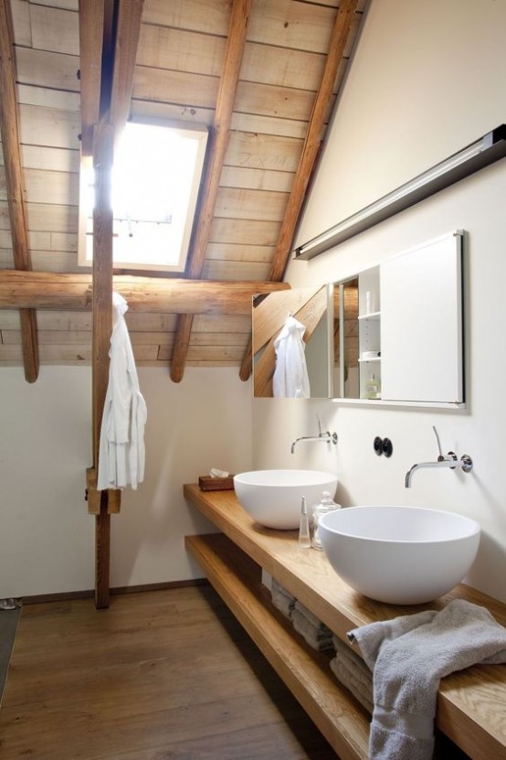 a modern farmhouse bathroom with a wooden ceiling, wooden beams, a floating vanity with sinks
