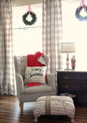 cozy plaid curtains, a red blanket and some pillows make the living room holiday-ready and very welcoming