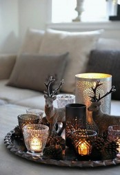 candles in various candleholders on a tray cozy up the space and make the living room more welcoming