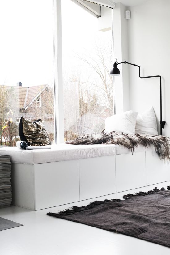 velvet pillows and a faux fur blanket cozy up this cool nook by the window and make it super welcoming and inviting