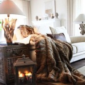 a luxurious faux fur blanket is amazing to snuggle up and to cozy up the space visually, too