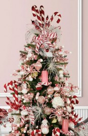 a peppermint styled Christmas tree topped with oversized candy canes is a perfect idea for a playful and super fun Christmas space
