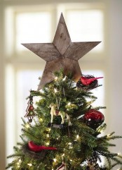 a simple reclaimed wood star tree topper is a great solution for a rustic Christmas tree and can be a match for a woodland one, too