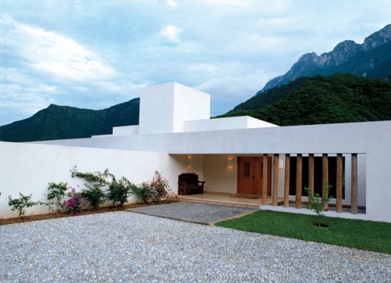 White Concrete House Surrounded By Greens And Blues Of Nature