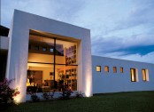 White Concrete House Surrounded By Greens And Blues Of Nature