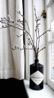 a black alcohol bottle with willow is a bold modern decoration to rock in spring