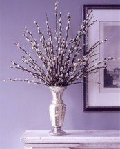 a large silver vase with willow branches is a refined and glam decoration for spring
