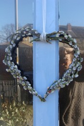 a willow heart-shaped wreath is a nice front door decoration for spring, Valentine’s Day and Easter