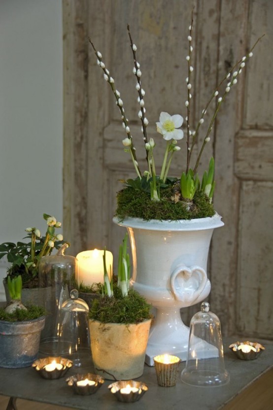 a vintage porcelain urn with moss, white bulbs and willow plus candles and more bulbs in pots as a spring or Easter centerpiece