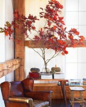 branches with bright red fall leaves and a couple of natural pumpkins will add a natural fall touch to the space