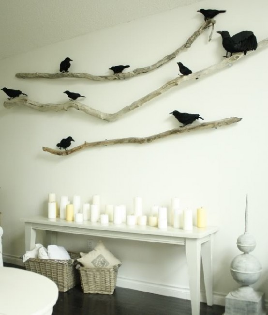 branches attached to the wall and black faux birds on them is a stylish Halloween decoration