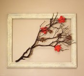 a fall artwork of an empty frame with branches and bright leaves is a cool idea