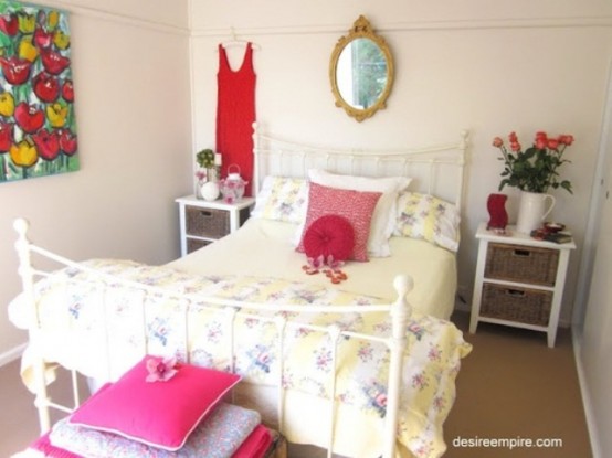 bright red and pink touches and a floral artwork make the bedroom feel like spring, bold and fresh